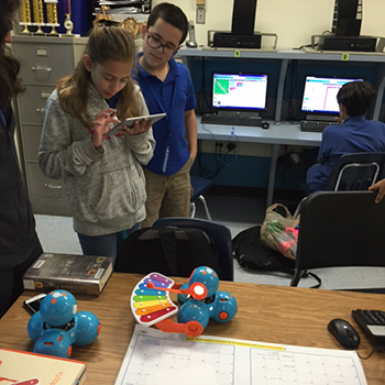 students playing with Dash robots