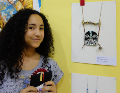 Student with their artwork